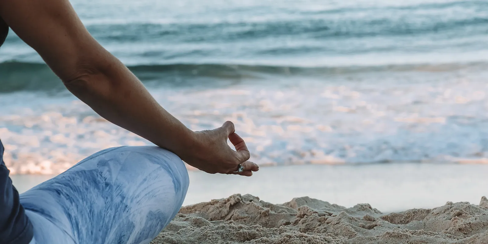 woman practising meditation on the seaside