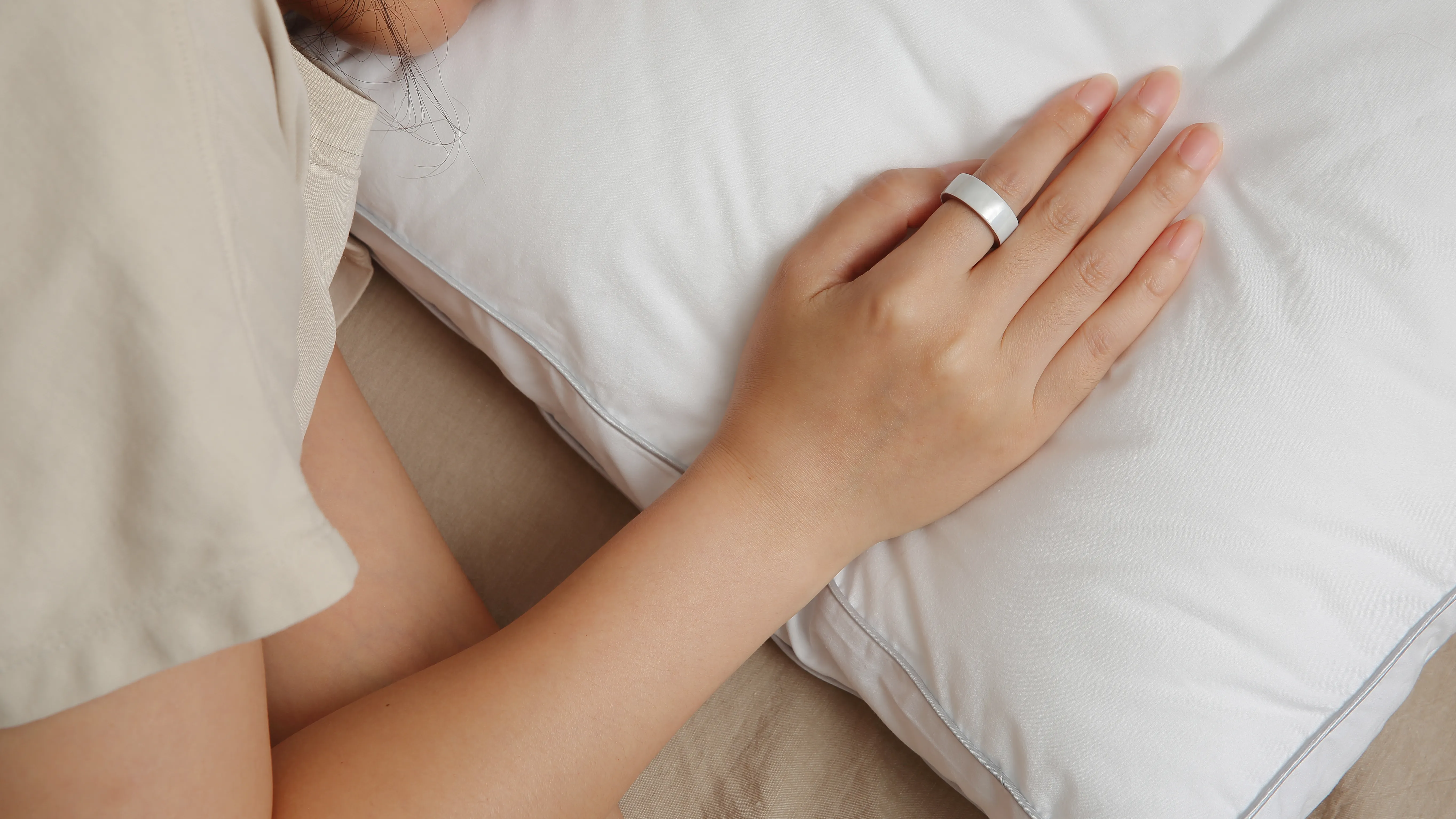 woman sleeping wearing Femometer Ring on her hand